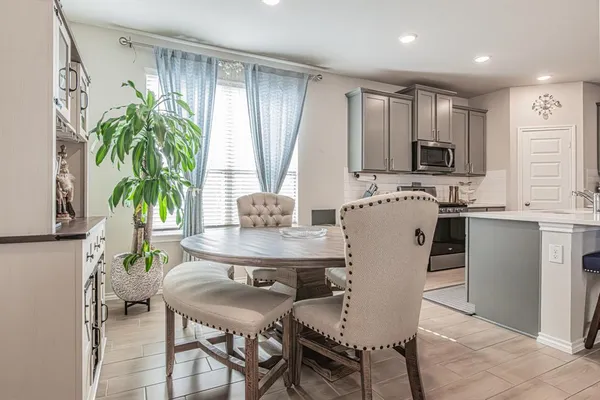 a view of a dining room with furniture and a potted plant