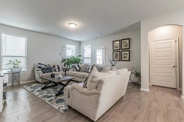 a living room with furniture and wooden floor
