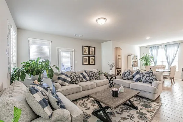 a living room with furniture and wooden floor