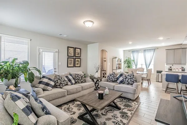 a living room with furniture potted plant and a window