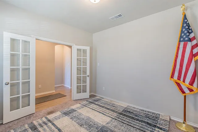 a view of wooden floor and windows in a room