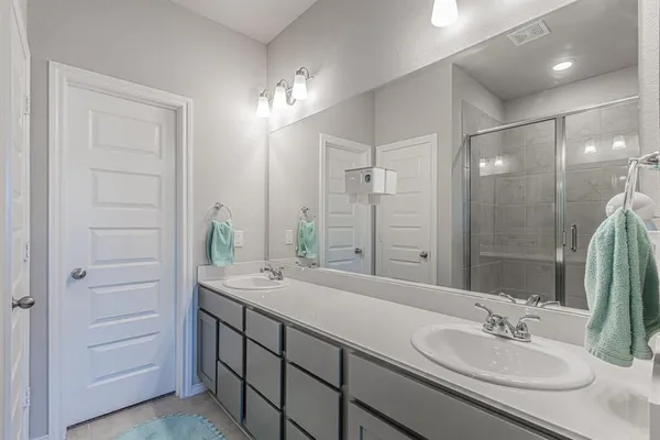 a bathroom with a sink double vanity and a mirror