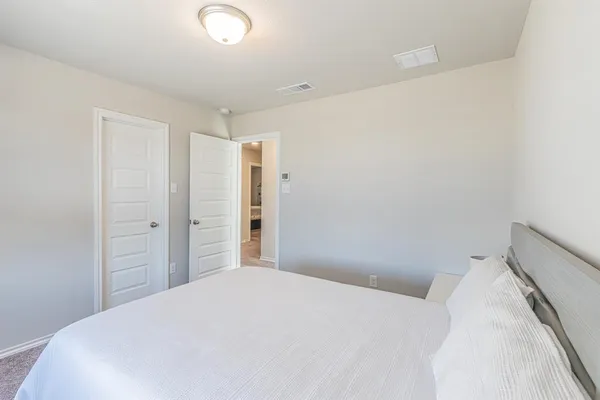 a bedroom with a bed and cabinets