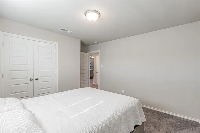 a bedroom with a bed and a cabinets