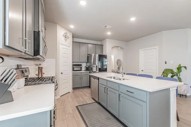 a kitchen with a sink stove and refrigerator