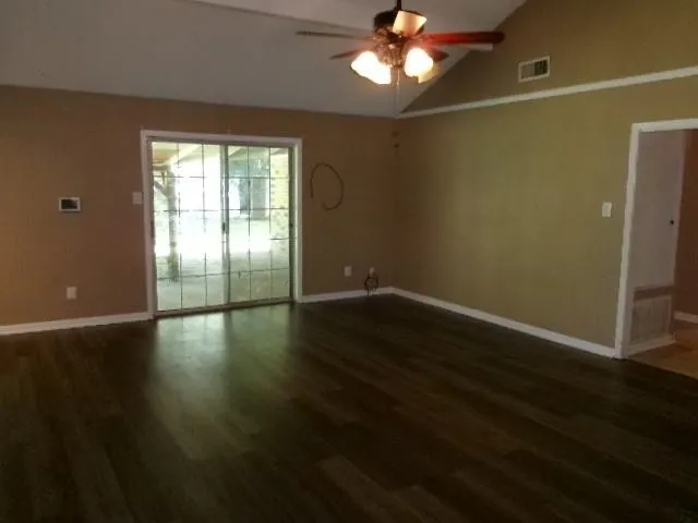 a view of wooden floor and windows in a room