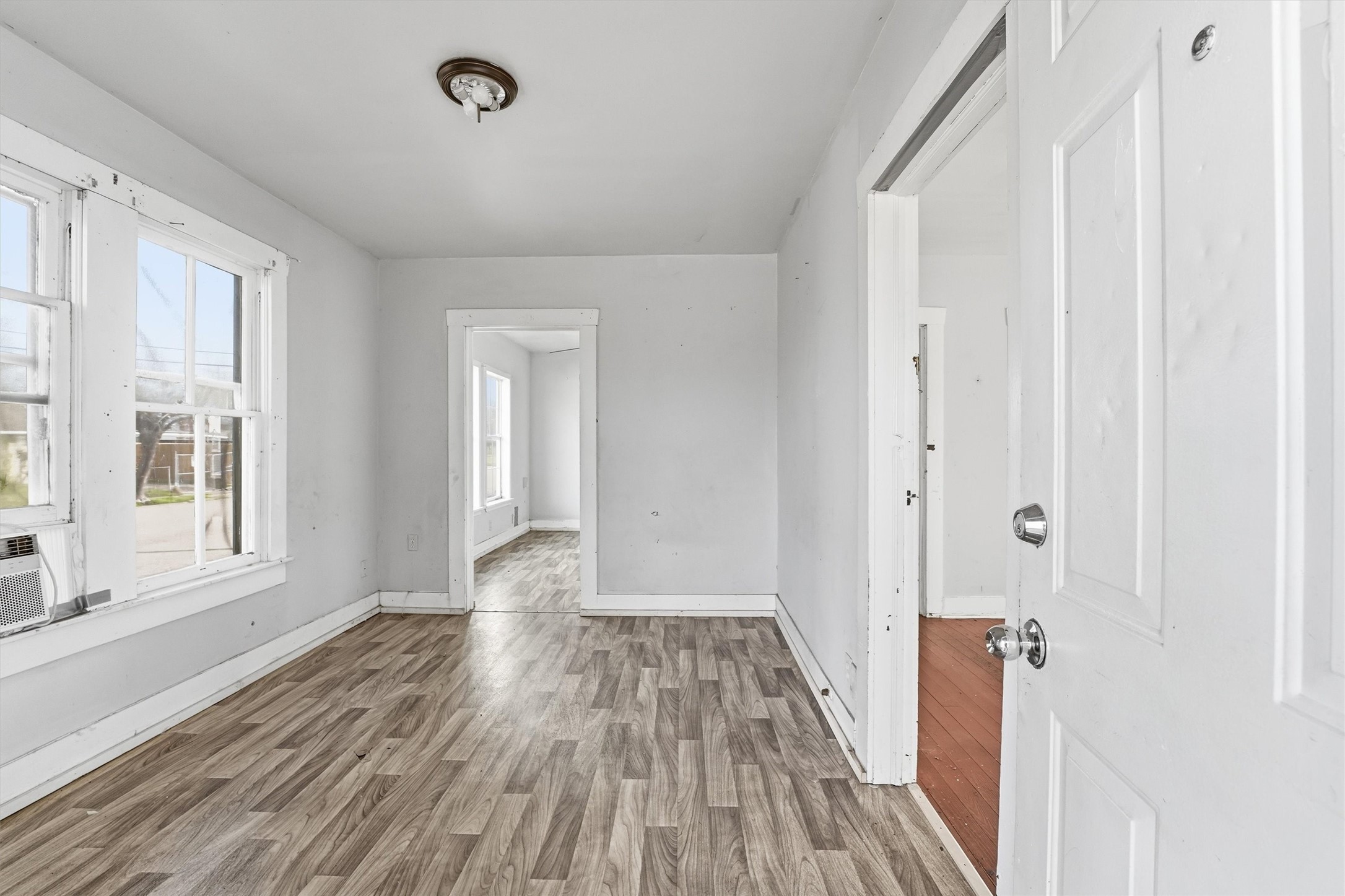 2420 Stevens Street Houston, TX 77026 - Photo 2 of 15 a view of a room with wooden floor and windows