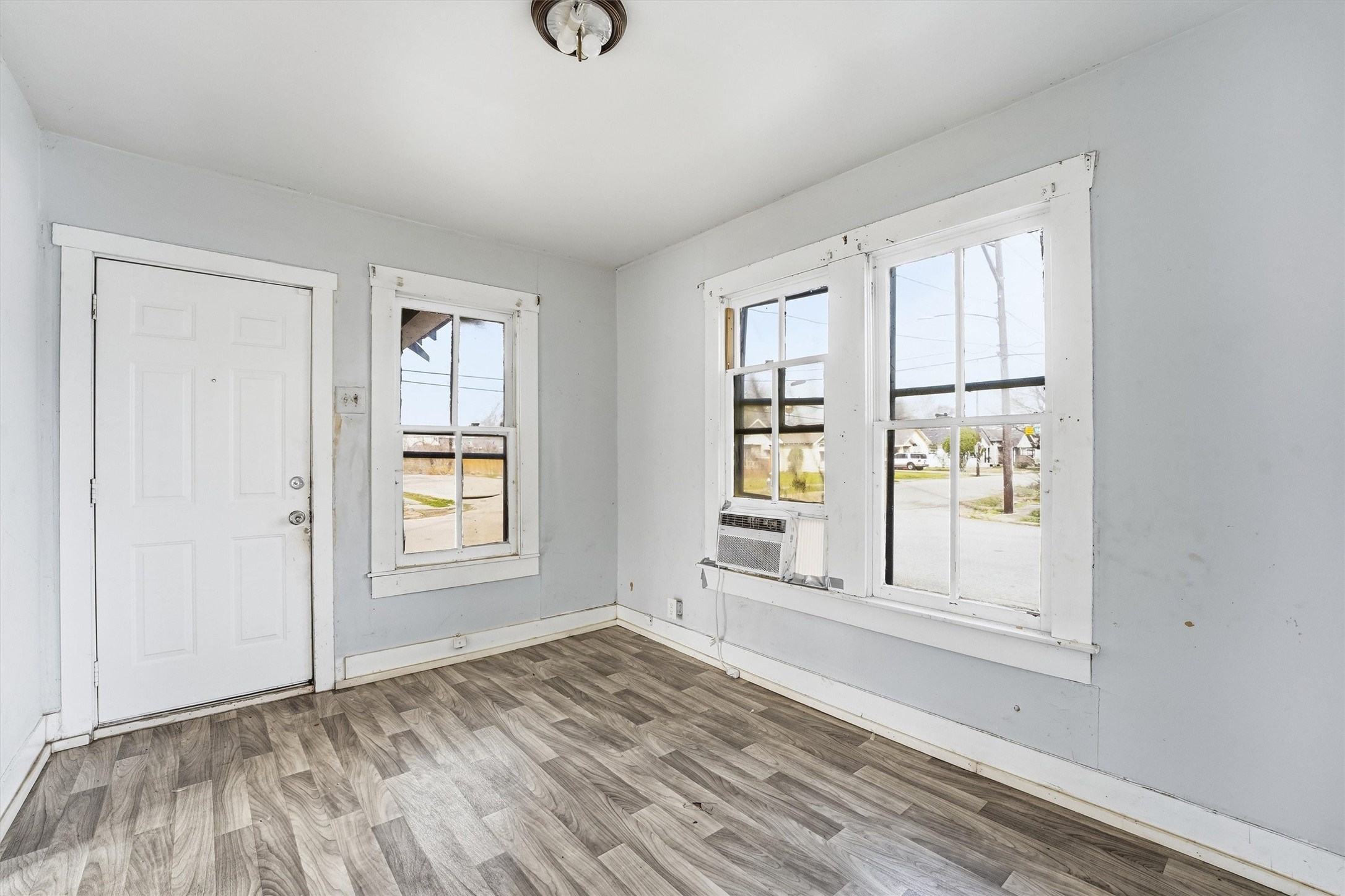 2420 Stevens Street Houston, TX 77026 - Photo 4 of 15 an empty room with wooden floor and windows