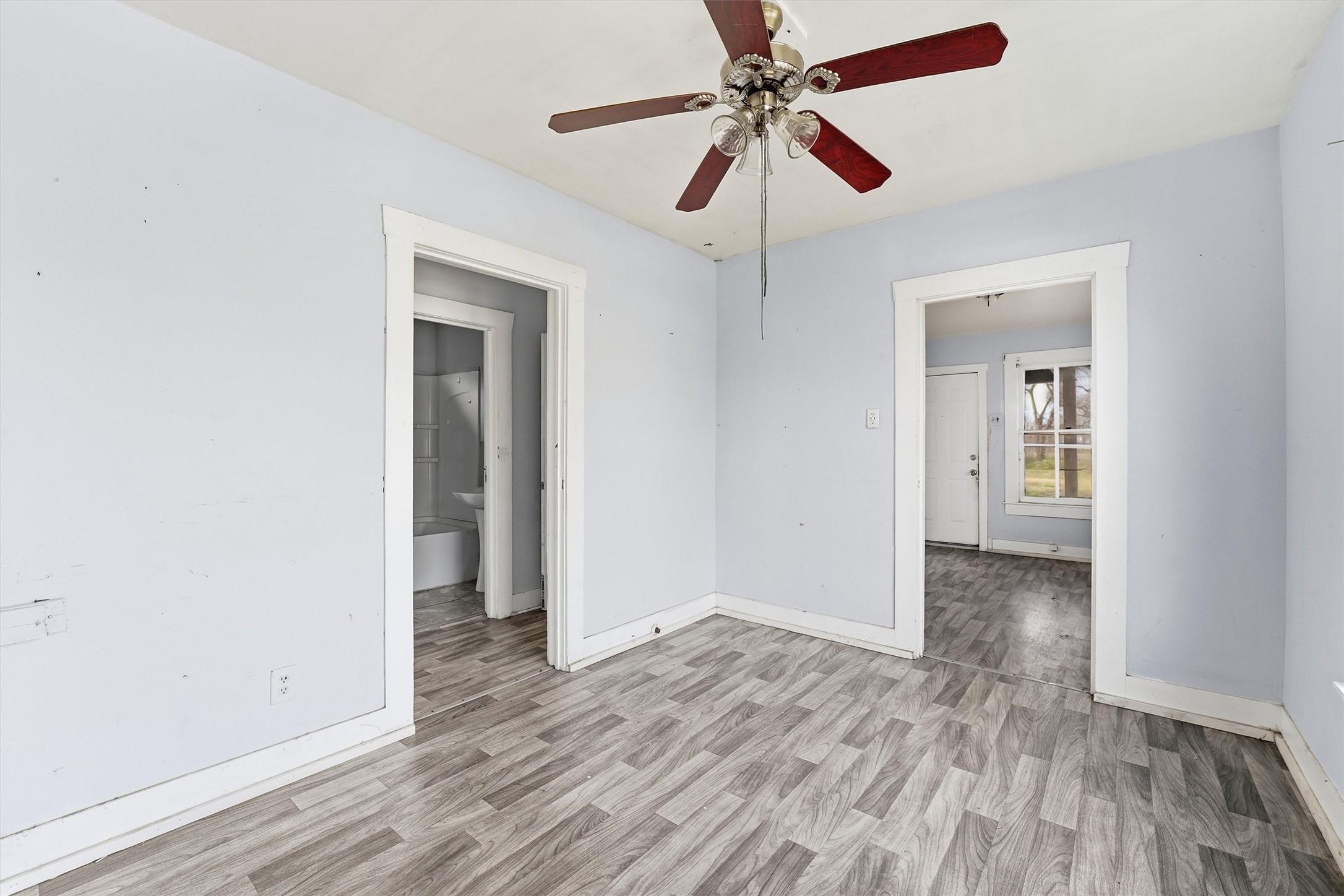 2420 Stevens Street Houston, TX 77026 - Photo 7 of 15 wooden floor in an empty room with a window