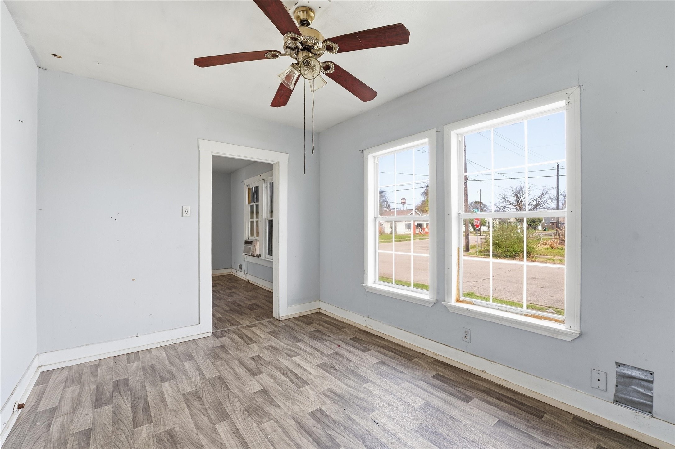 2420 Stevens Street Houston, TX 77026 - Photo 8 of 15 a view of an empty room with a window and wooden floor