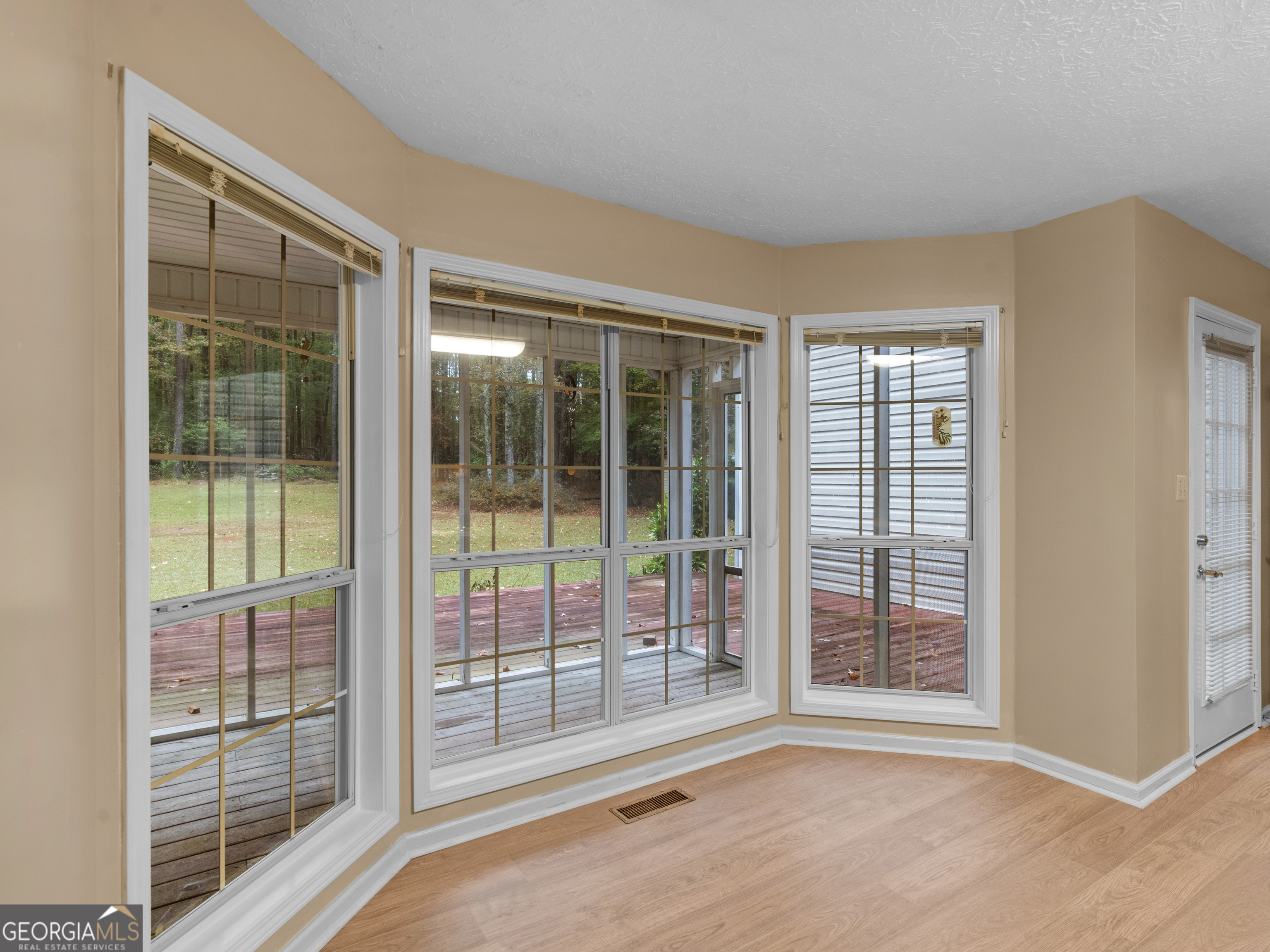 12012 Turner Road Hampton, GA 30228 - Photo 11 of 38 a view of an empty room with wooden floor and a window