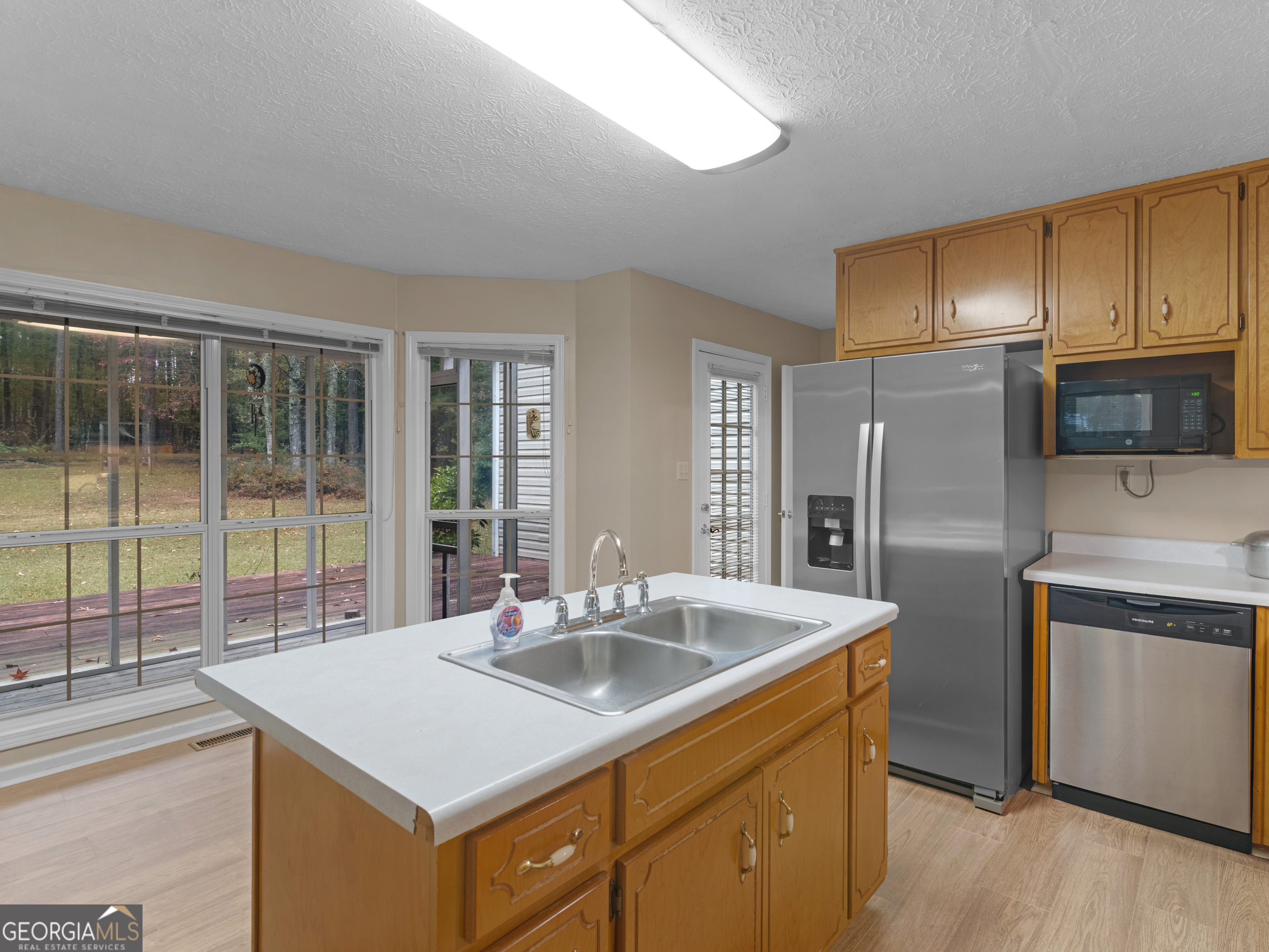 12012 Turner Road Hampton, GA 30228 - Photo 6 of 38 a kitchen with stainless steel appliances granite countertop a sink a stove and a refrigerator