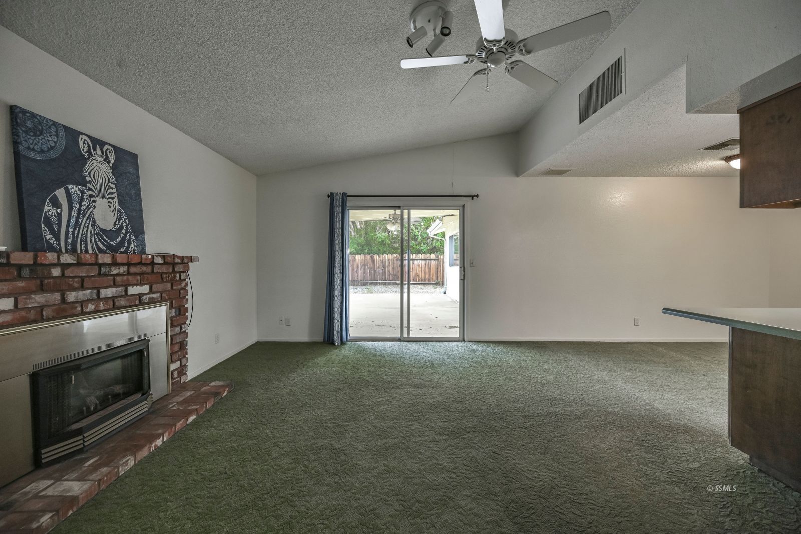 628 South Gemstone Street Ridgecrest, CA 93555 - Photo 20 of 24 an empty room with windows and fireplace