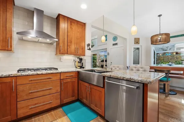 a kitchen with stainless steel appliances granite countertop a stove and a sink