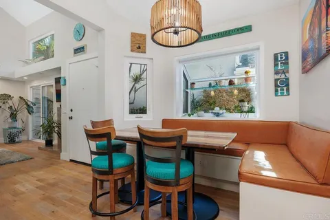a view of a dining room with furniture wooden floor and chandelier