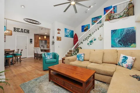 a living room with furniture and a dining table