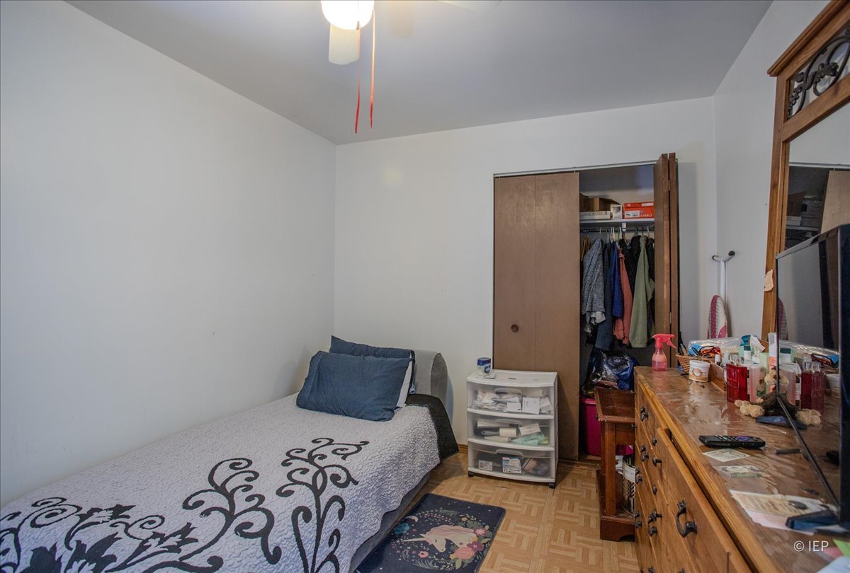 1104 Cora Street Joliet, IL 60435 - Photo 14 of 20 a bedroom with a bed and a dresser