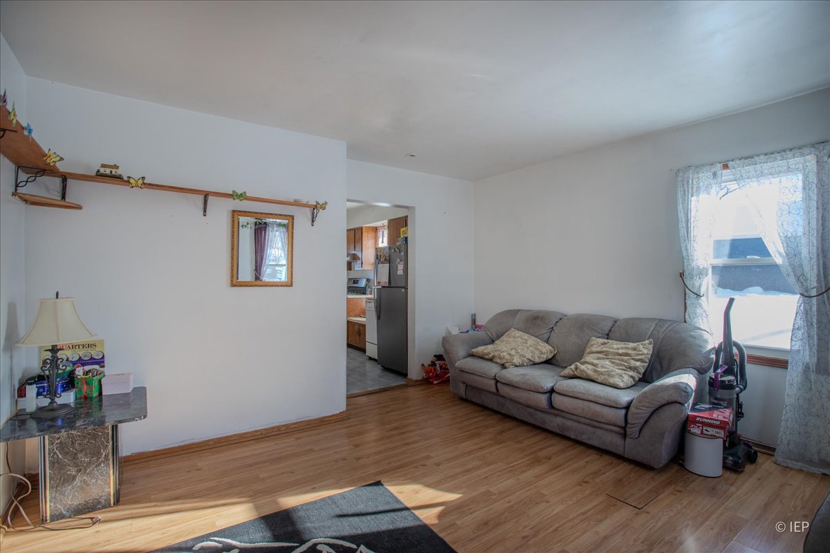 1104 Cora Street Joliet, IL 60435 - Photo 5 of 20 a living room with furniture and wooden floor