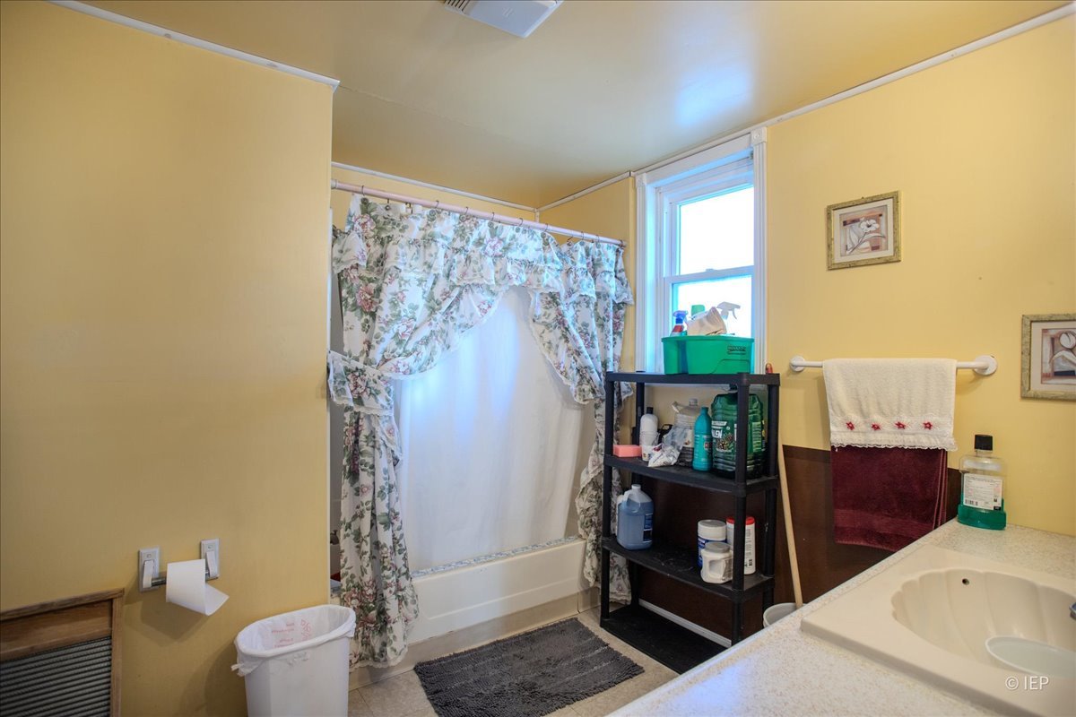 1104 Cora Street Joliet, IL 60435 - Photo 10 of 20 a bathroom with a sink toilet and shower
