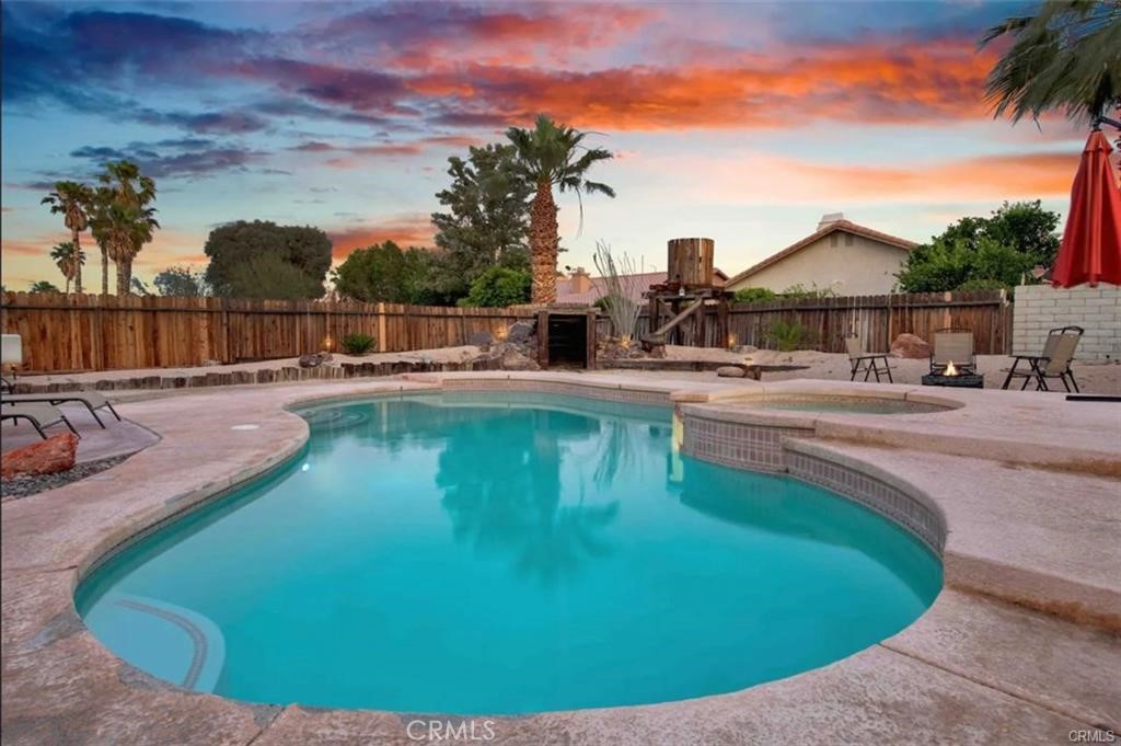 68935 Durango Road Cathedral City, CA 92234 - Photo 1 of 1 a view of a swimming pool with an outdoor seating