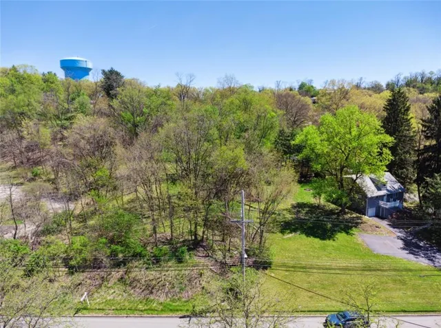 an aerial view of a houses with yard