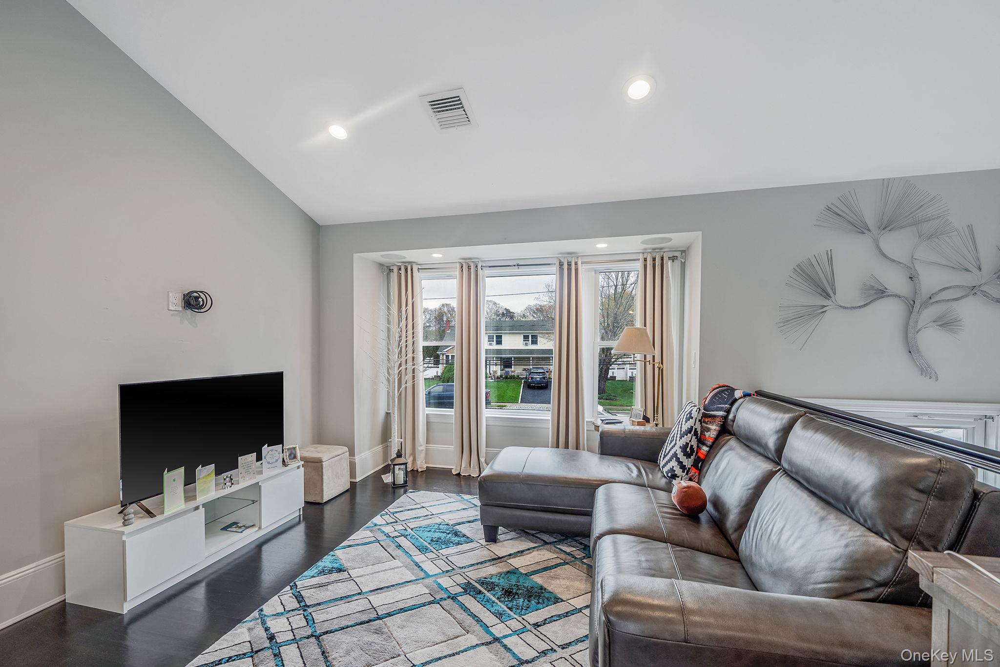 110 Stephen Road Bayport, NY 11705 - Photo 13 of 39 a living room with furniture and a flat screen tv