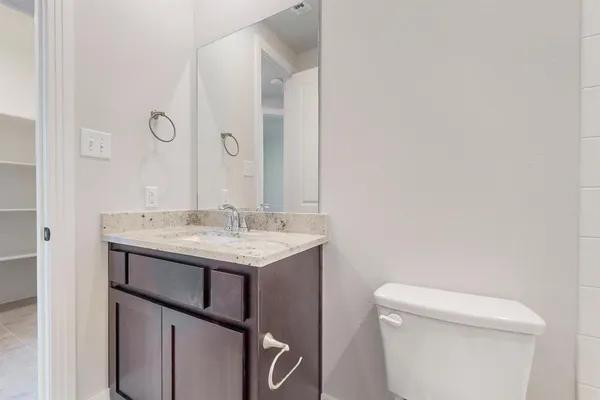 a bathroom with a sink a toilet and a mirror