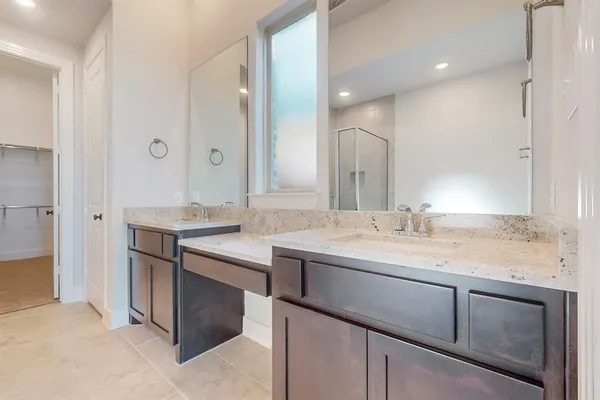 a bathroom with a granite countertop sink double and mirror