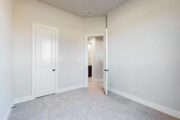 a view of an empty room and closet area