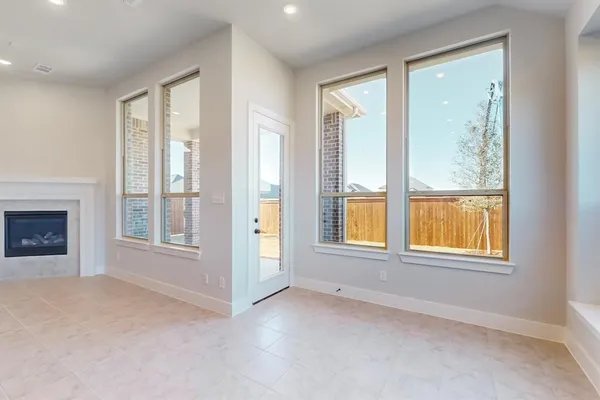an empty room with windows and view of an empty room