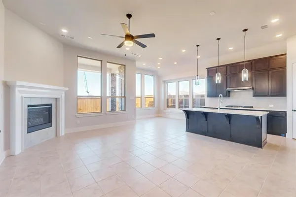 a large kitchen with stainless steel appliances kitchen island granite countertop a large counter top and a stove top oven