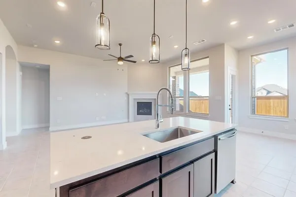 a kitchen with kitchen island a sink appliances and a counter top space