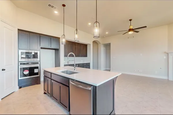 a kitchen with a stove a sink and a refrigerator