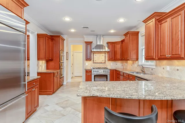 a large kitchen with stainless steel appliances lots of counter top space