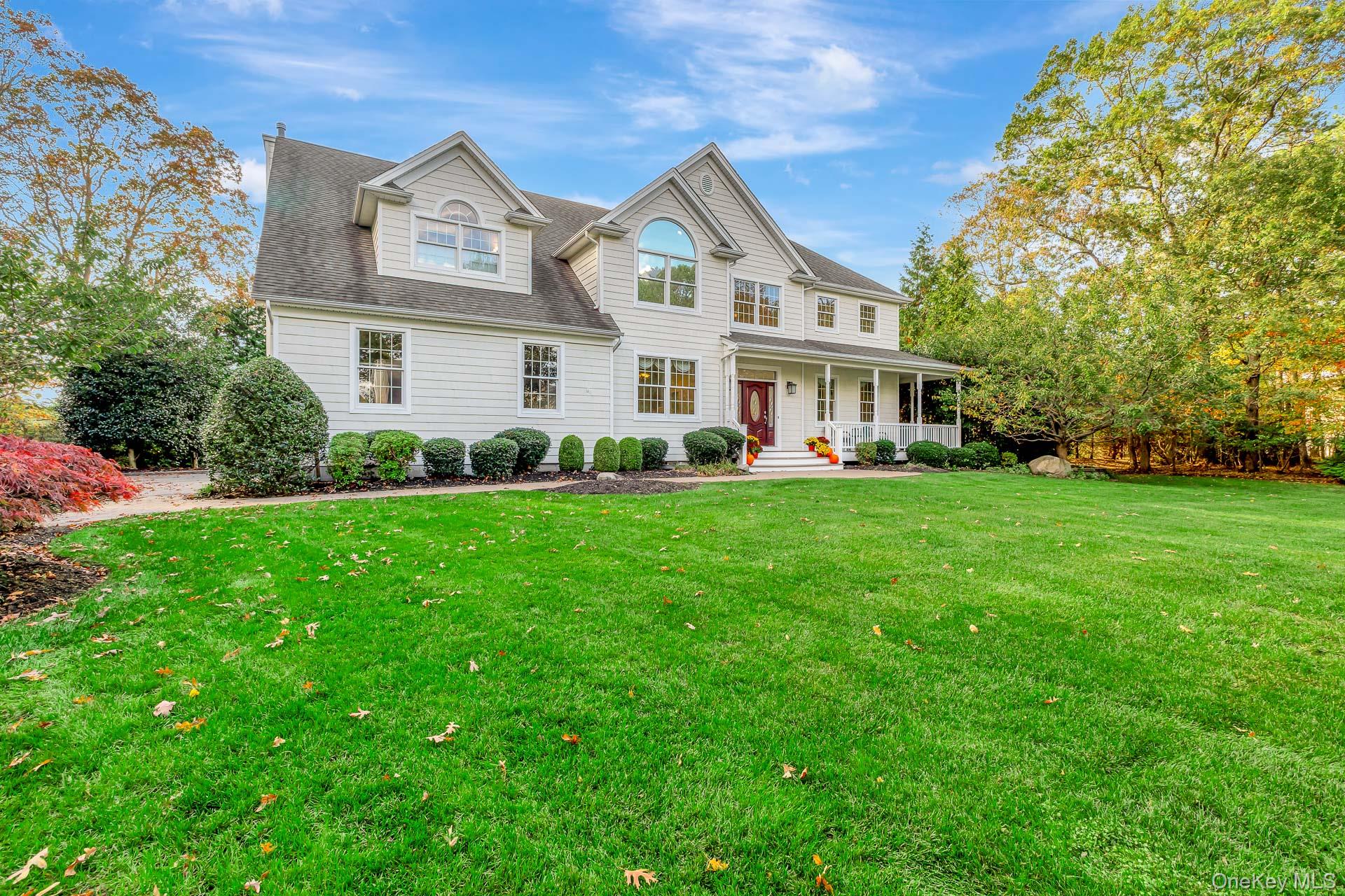 4 Martin Avenue Shoreham, NY 11786 - Photo 2 of 50 a front view of a house with a garden and trees