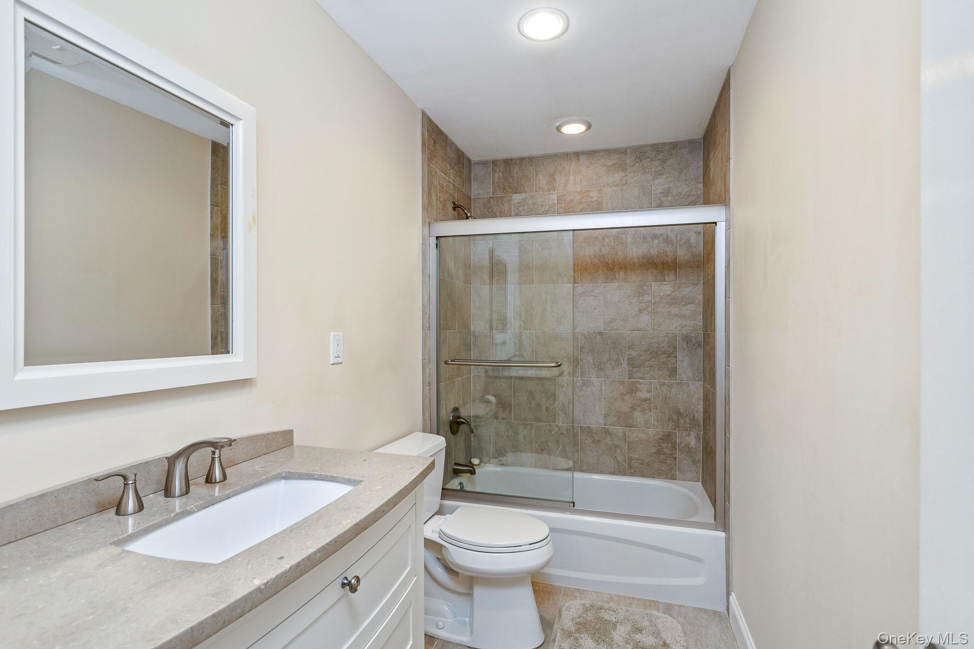 4 Martin Avenue Shoreham, NY 11786 - Photo 31 of 50 a bathroom with a bathtub shower sink mirror and toilet