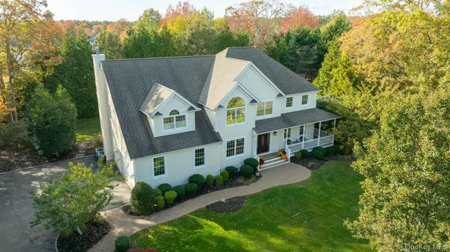 an aerial view of a house with outdoor space and a lake view