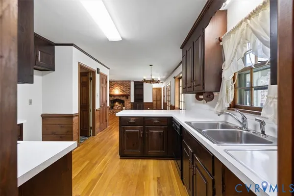 a kitchen with stainless steel appliances granite countertop a sink a stove and a refrigerator