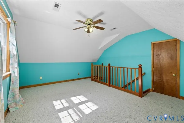a view of a room with window a ceiling fan and front door