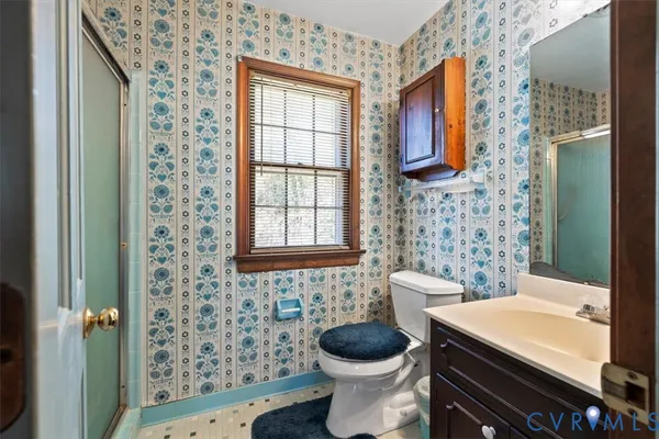 a bathroom with a toilet a sink and a shower