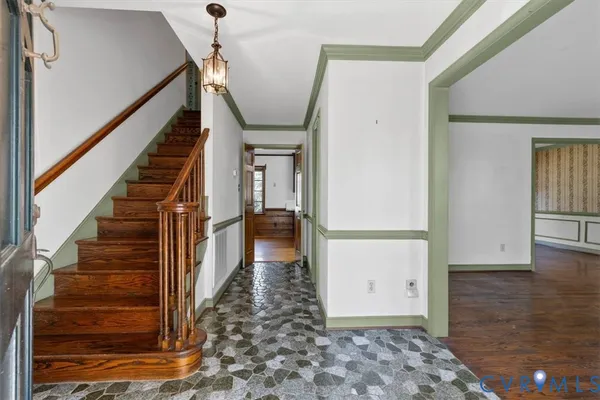 a view of entryway and hall with wooden floor