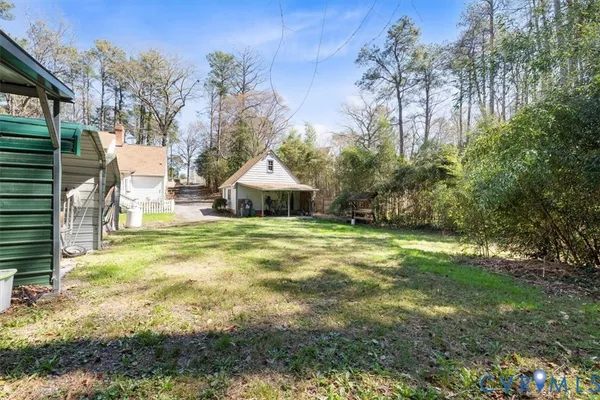 a view of a house with a yard and sitting area