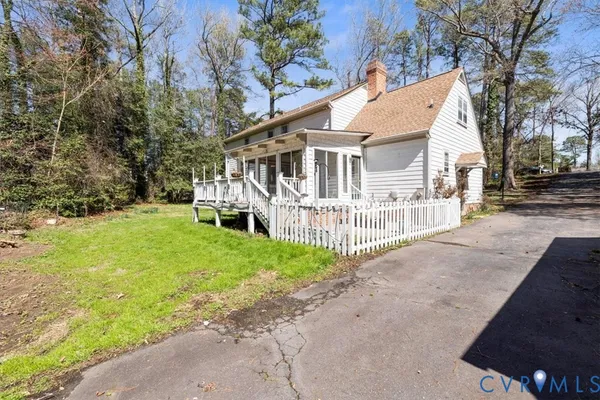 a view of a house with a yard and sitting area