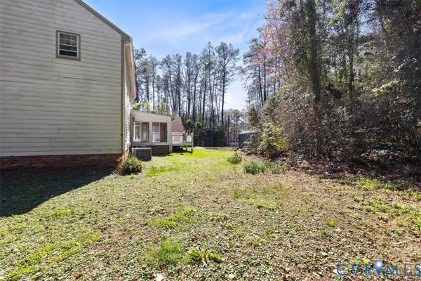 a view of a house with a yard and pathway