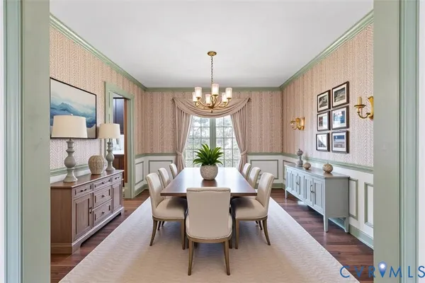 a view of a dining room with furniture and chandelier