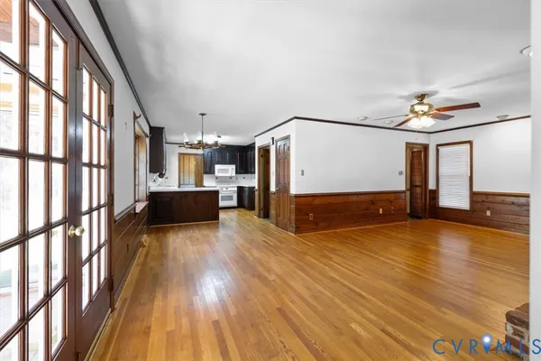a view of a living room with furniture and kitchen view