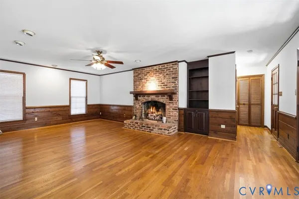 a view of a livingroom with furniture a fireplace and wooden floor