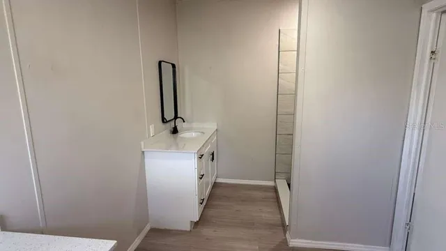 a bathroom with a sink and mirror