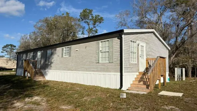 a view of a house with a large tree