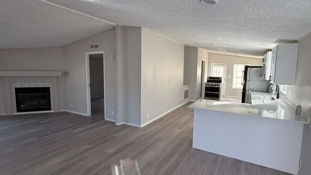 a view of a kitchen with wooden floor and a kitchen